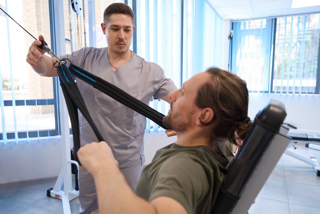 Physiotherapy instructor with patient doing rehabilitation exercises